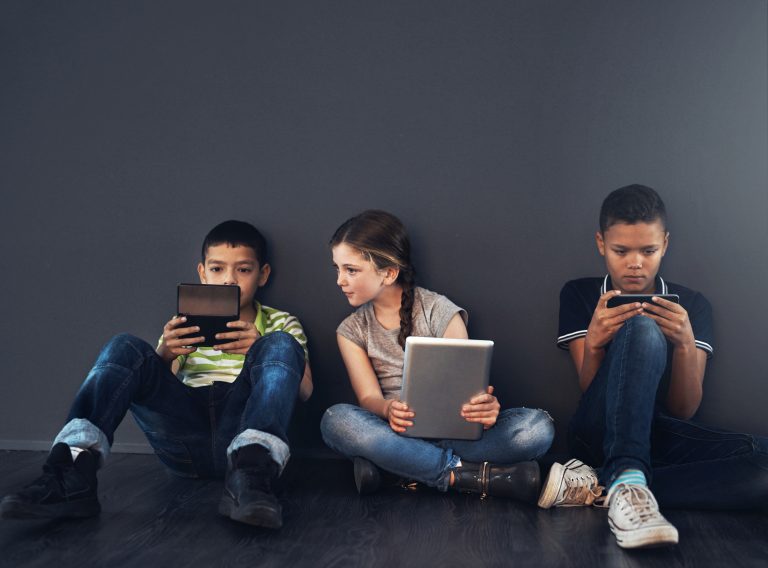 kids-friends-serious-with-technology-studio-connection-educational-games-gray-background-people-students-smile-as-elementary-school-learners-internet-brain-development