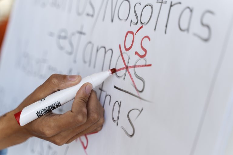 side-view-hand-writing-white-board