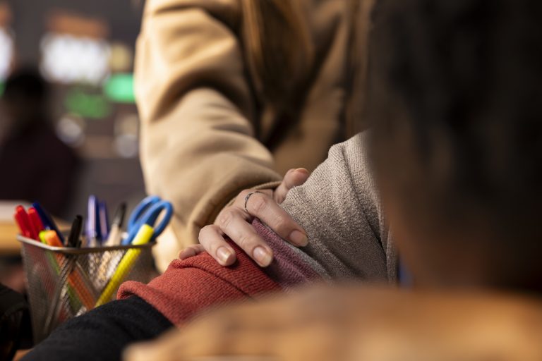 Young girl wakes up her colleague in the campus library after falling asleep